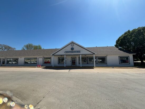 Front exterior of a single-story Centerstone building with a covered entrance and parking area.