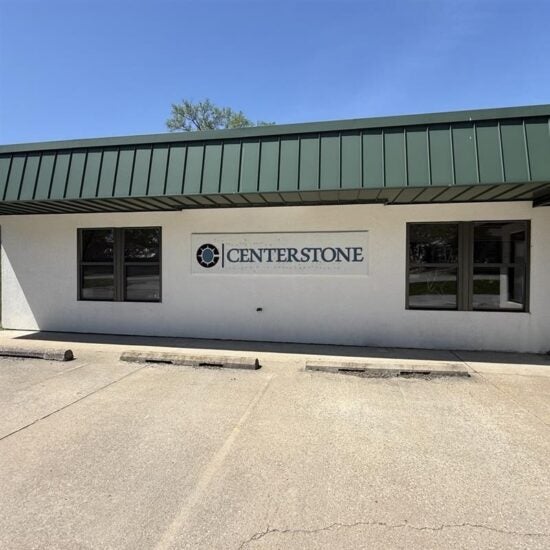 Centerstone sign on the exterior wall of a one-story building with a green metal awning.