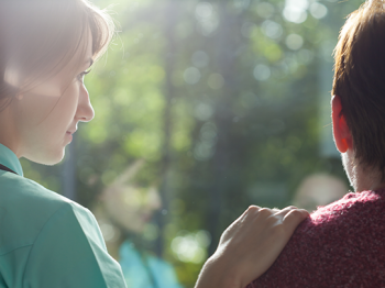 Woman comforting a young adult who feels guilty