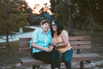 mother daughter hugging on bench