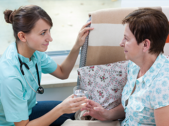 Nurse helping woman with her Medication Assisted Addiction Recovery treatment