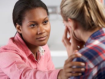Counselor comforting client during visit to outpatient clinic