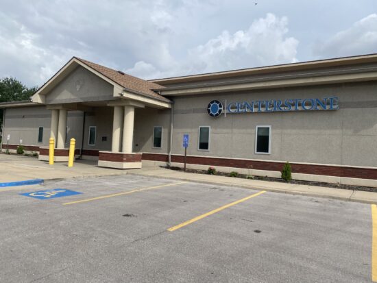 Exterior of a Centerstone building with a covered entrance and accessible parking spaces.