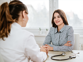 Female nurse conducting psychiatric evaluation on female patient