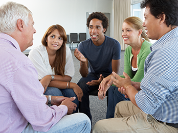 Group therapy session focused on helping young men and women identify triggers and coping skills.