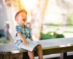 Boy with book smiling