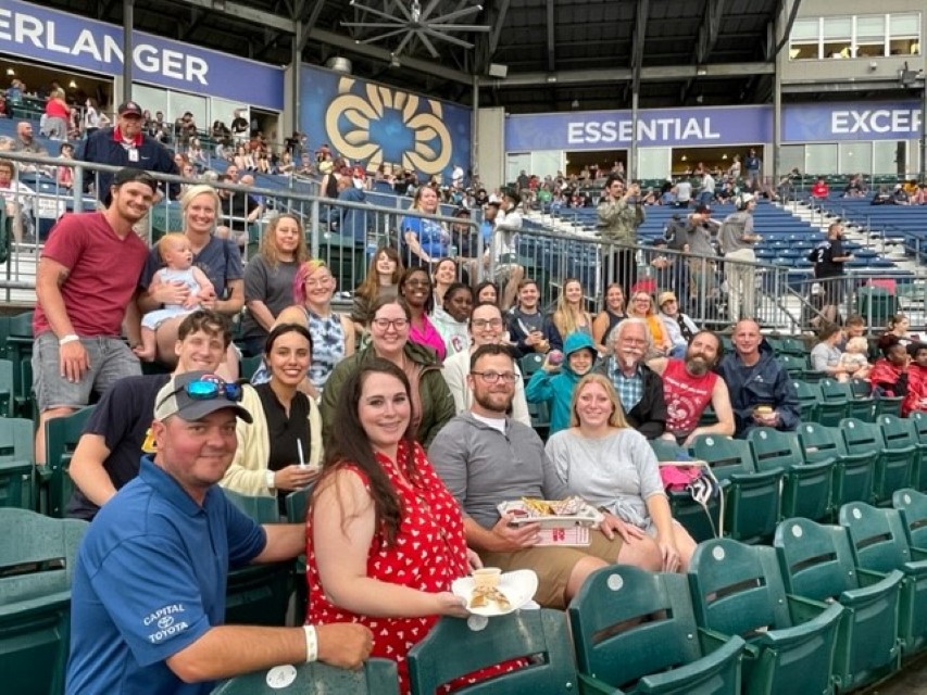Centerstone staff, family, and friends gathered in the seats at a local baseball game enjoying some snacks.
