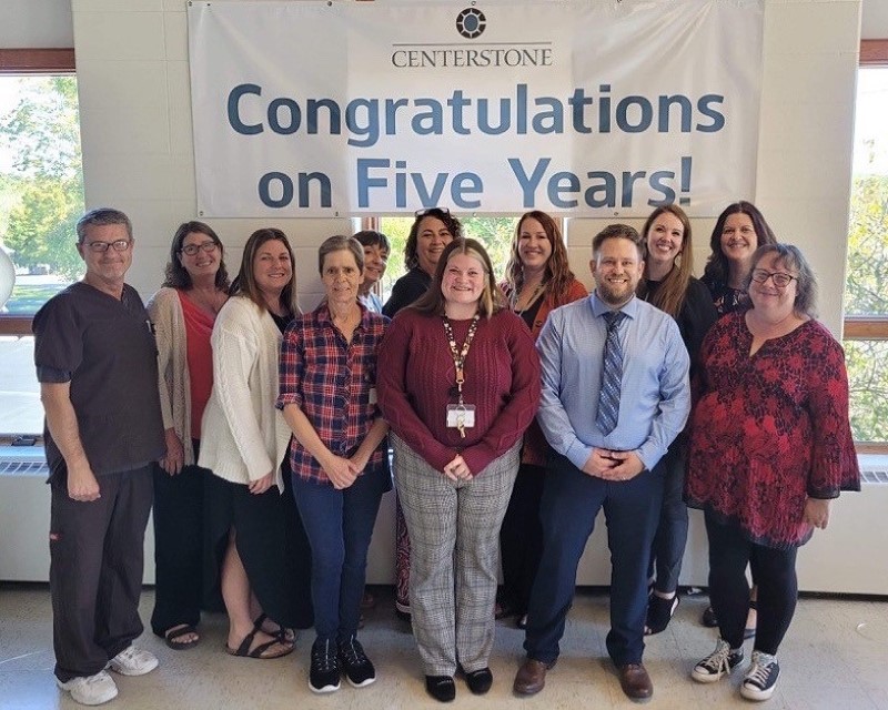 A group of clinical and administrative staff at a Centerstone Recovery Center gathered for a photo beneath a banner reading "Congratulations on Five Years!"