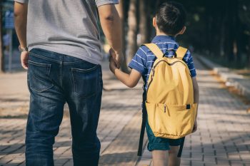 Father and son going to kindergarten