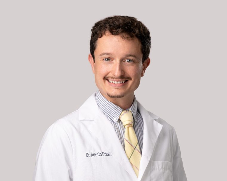Portrait of Austin Prince, M.D. in a white lab coat