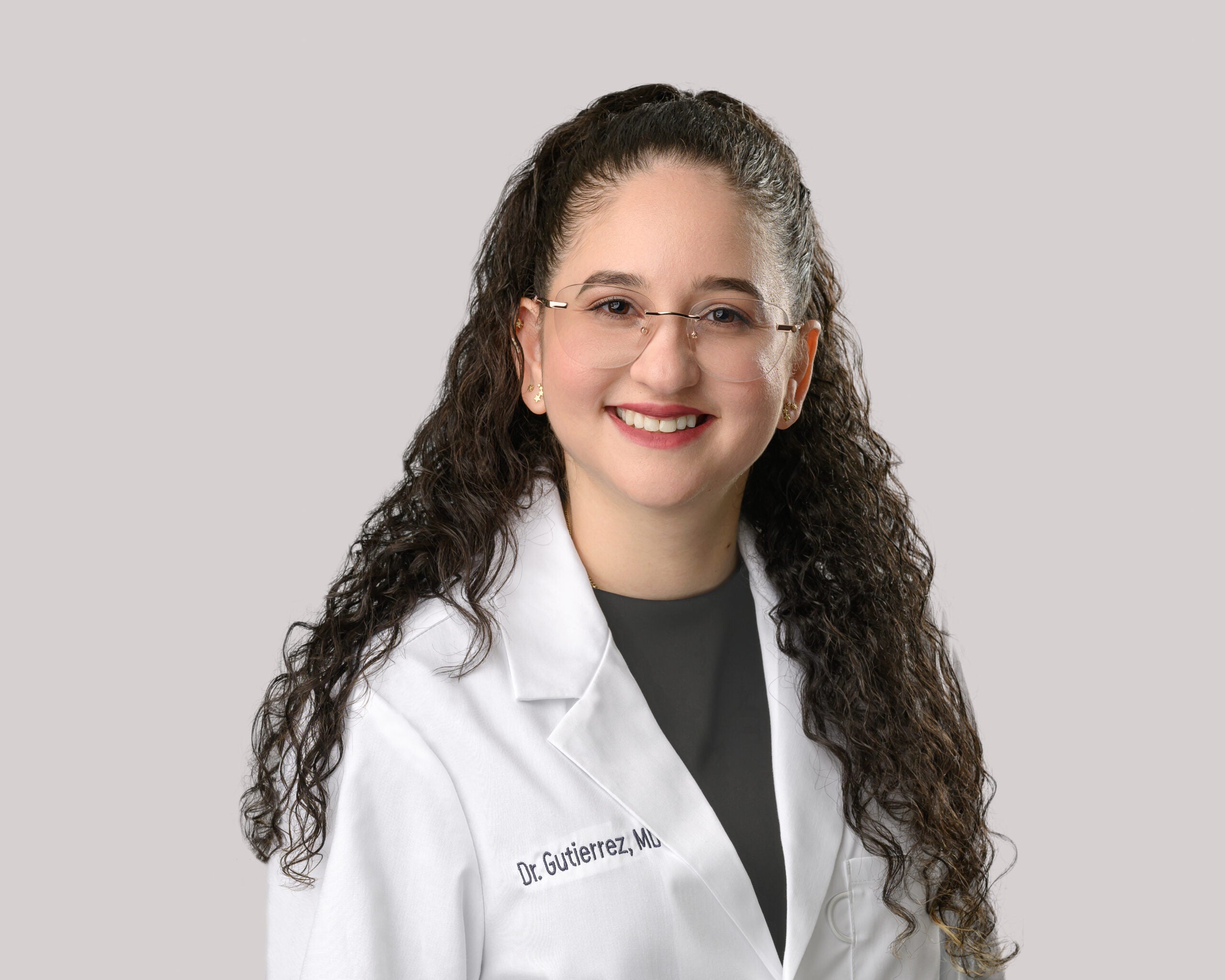 Portrait of Antonieta Gutierrez, M.D. in a white lab coat