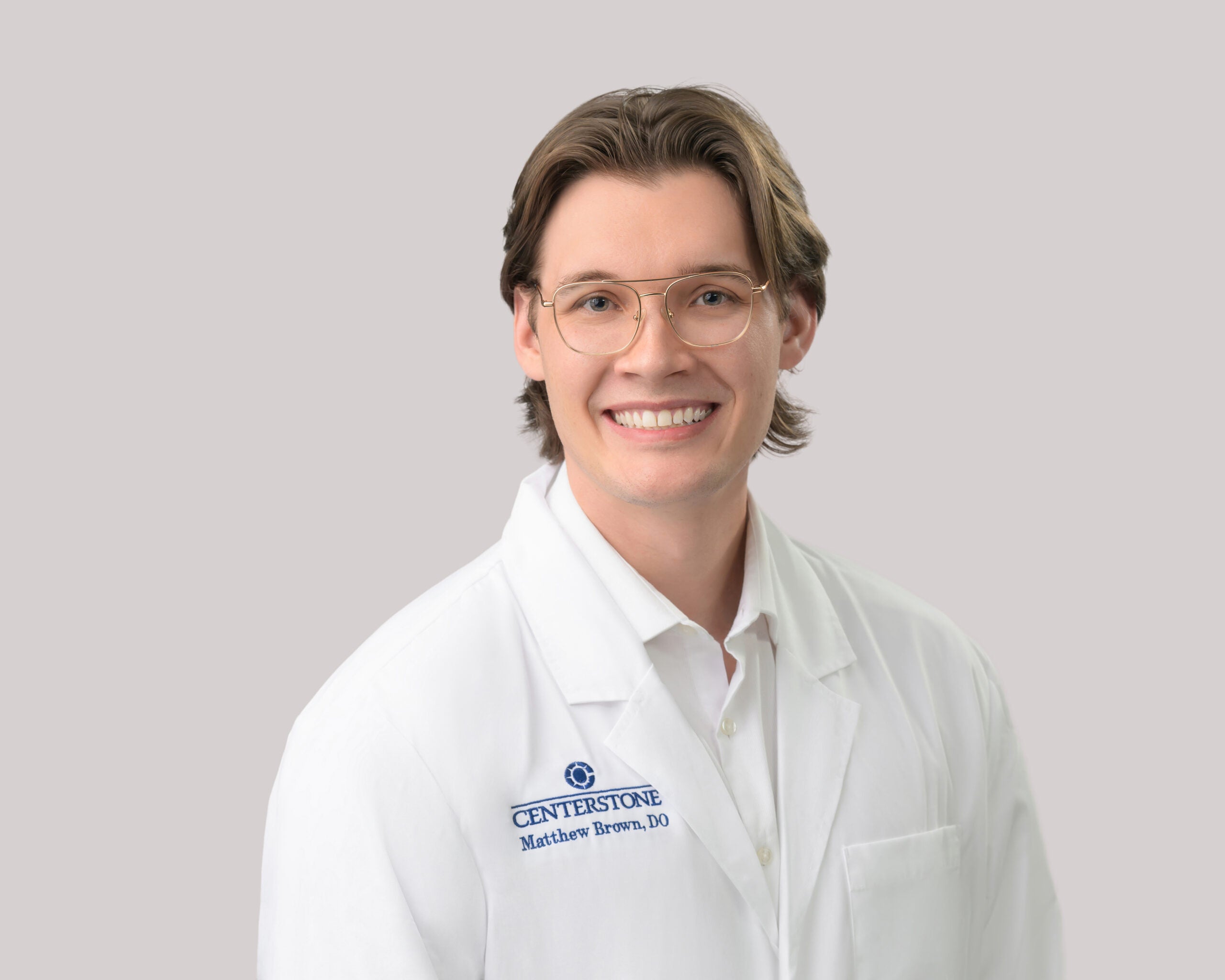 Portrait of Matthew Brown, D.O. in a white lab coat