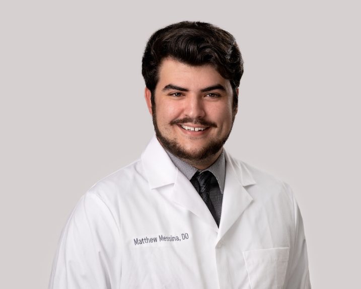 Portrait of Matthew Messina, D.O. in a white lab coat