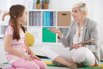 Girl talking with school pedagogue Girl talking with school pedagogue