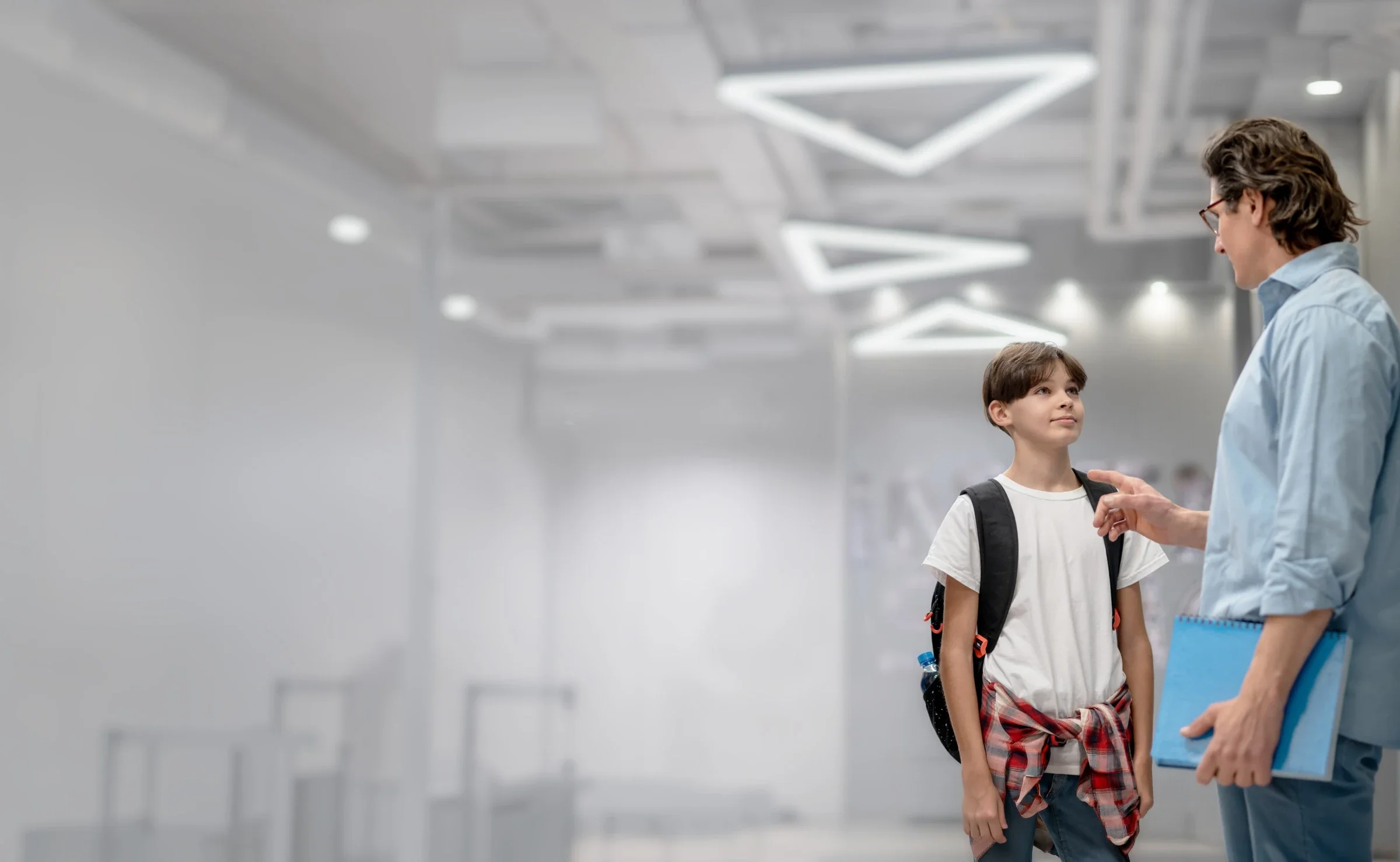 A provider talking with a student inside a school