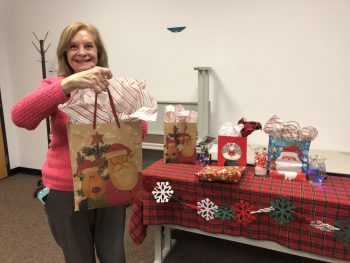 Sunrise Rotarian Jean Ozols is pictured handing out Christmas gifts